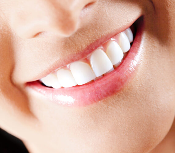 Detail shot of a pretty young female smiling.